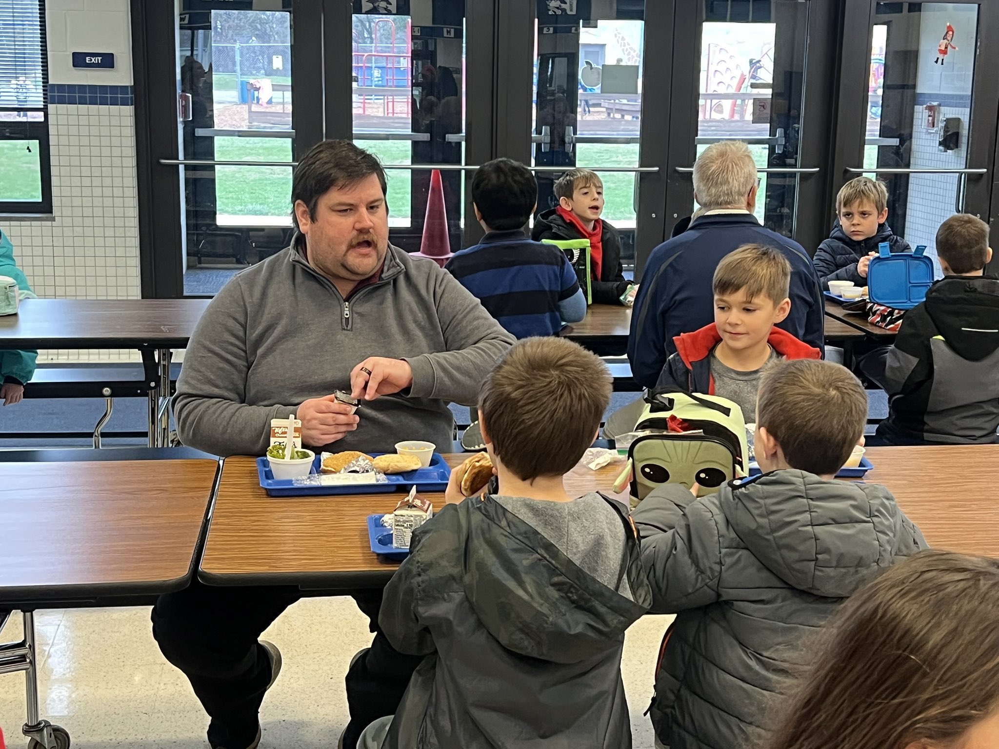 board members enjoy lunch with students at monlova primary