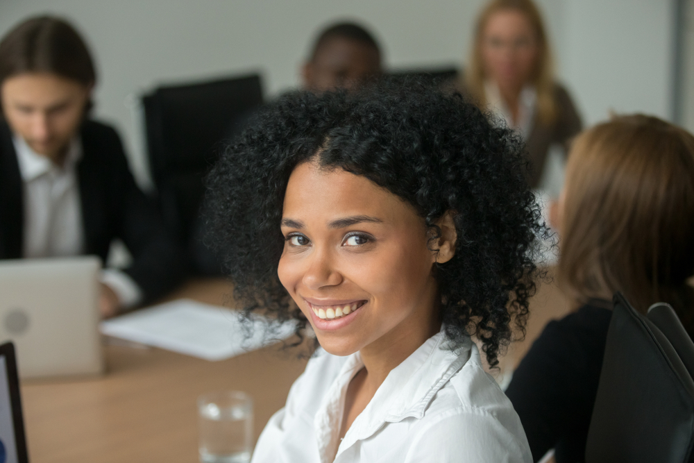 Woman in office workspace smiling