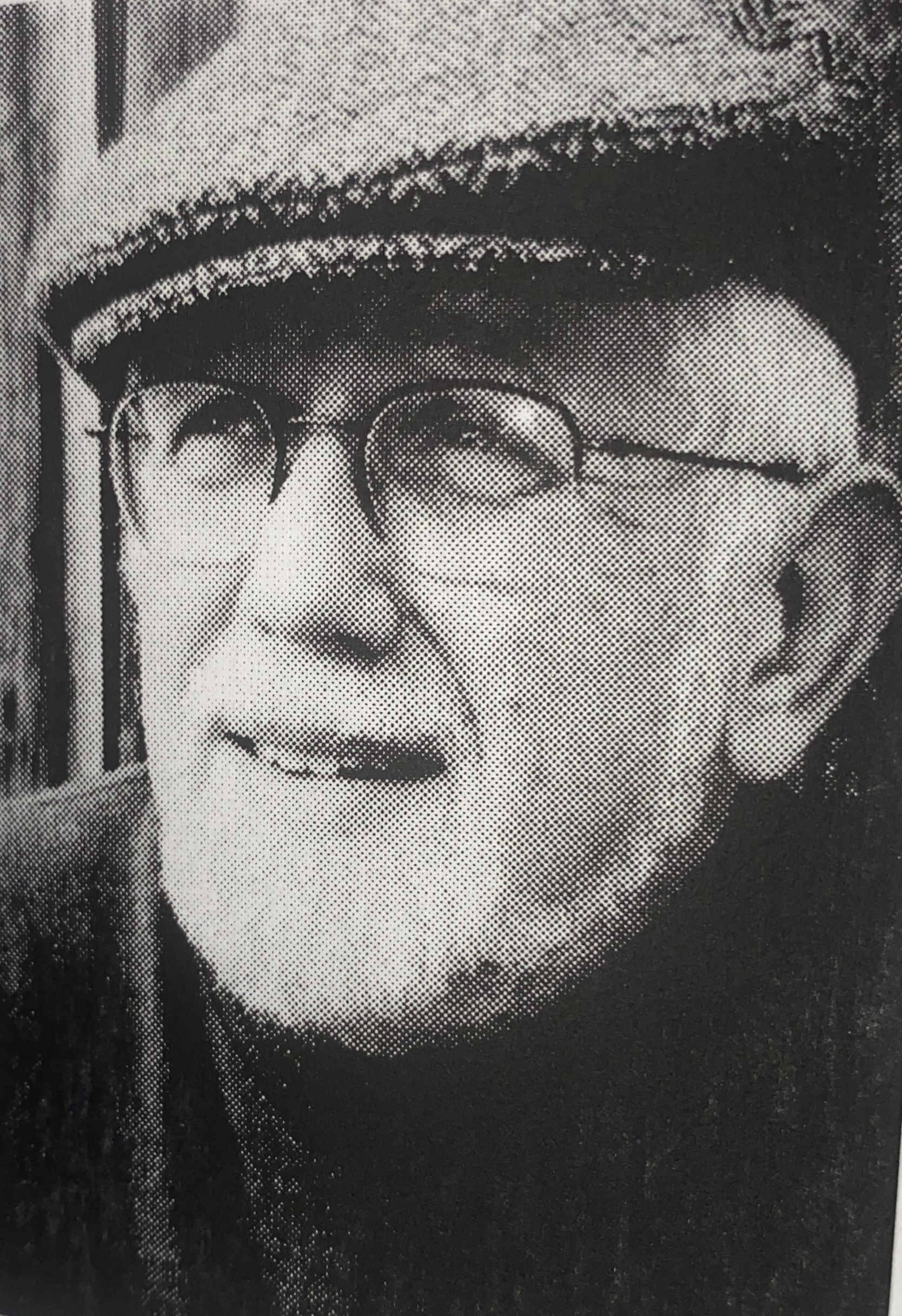 man looking away from camera wearing glasses and hat