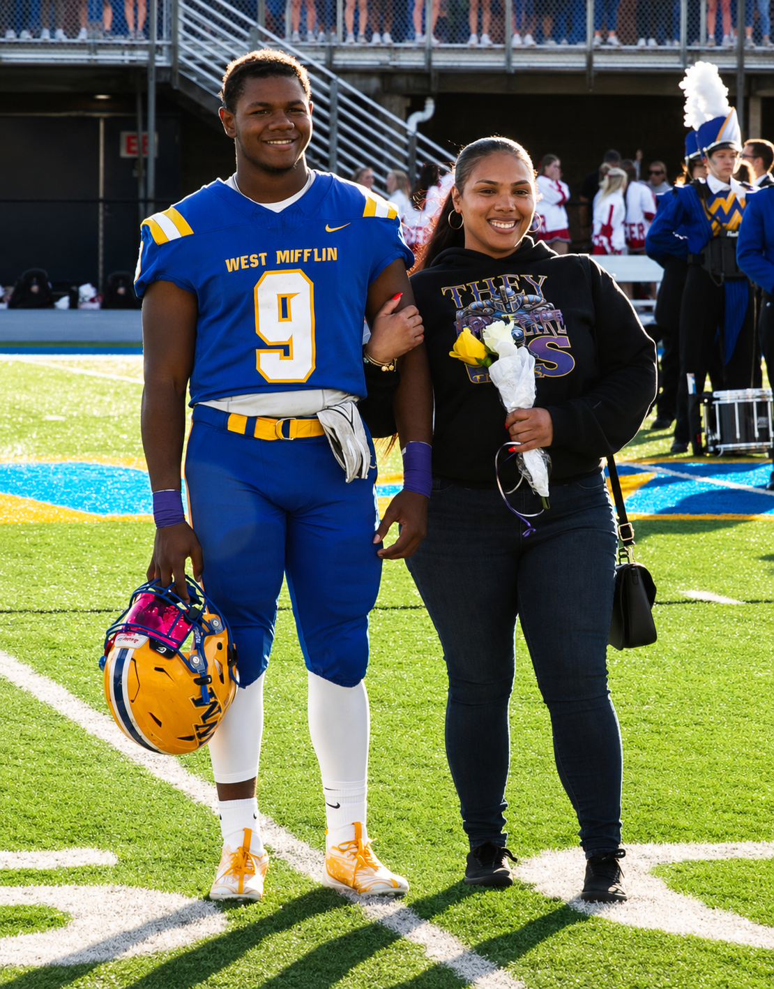 Football player with his mom on the field