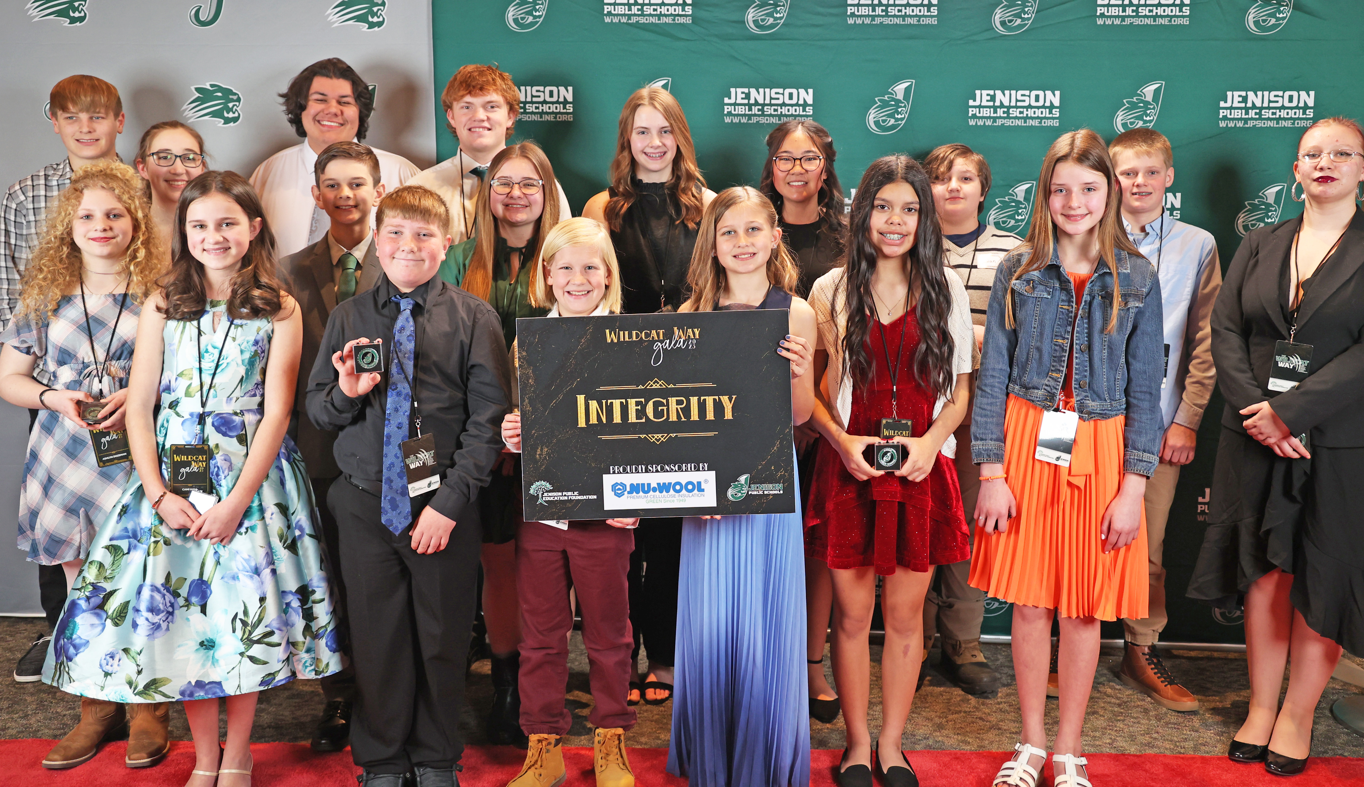 A group of students are photographed, being recognized for the "Integrity" characteristic trait, as part of "The Wildcat Way".