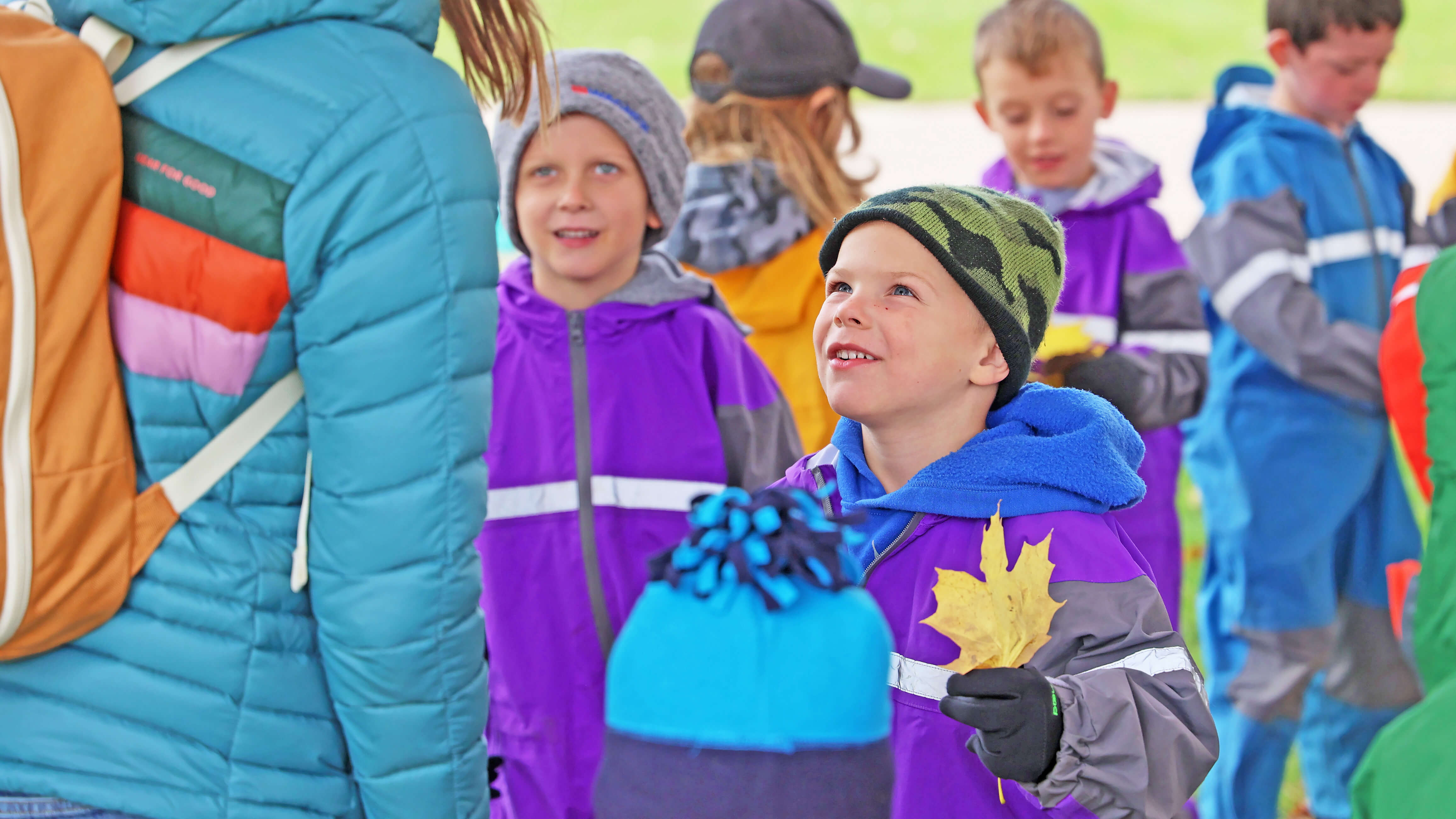 Preschoolers outside learning about leafs