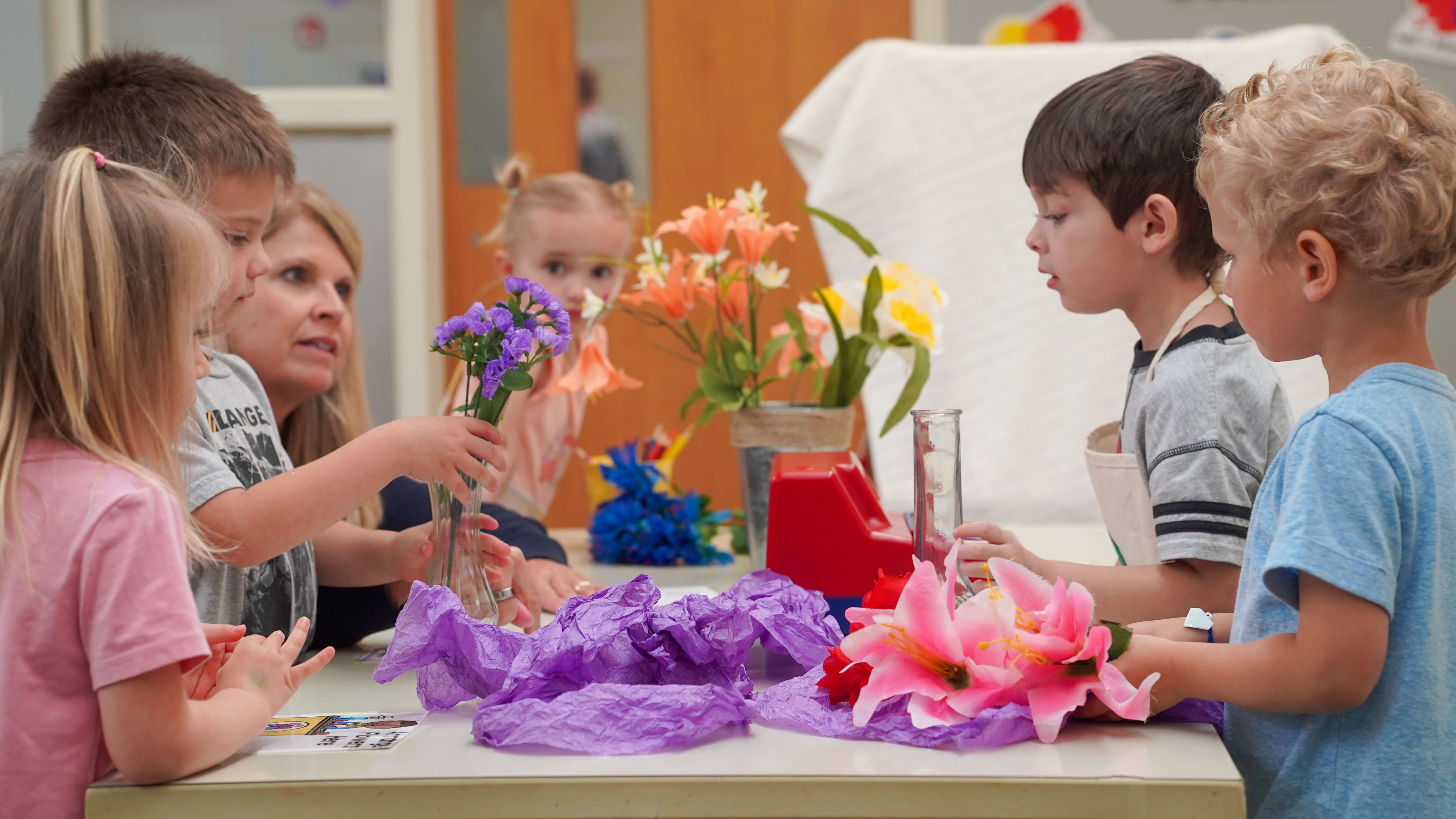 Group of preschool students learning about flowers