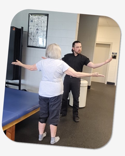 personal trainer and Y member raising arms