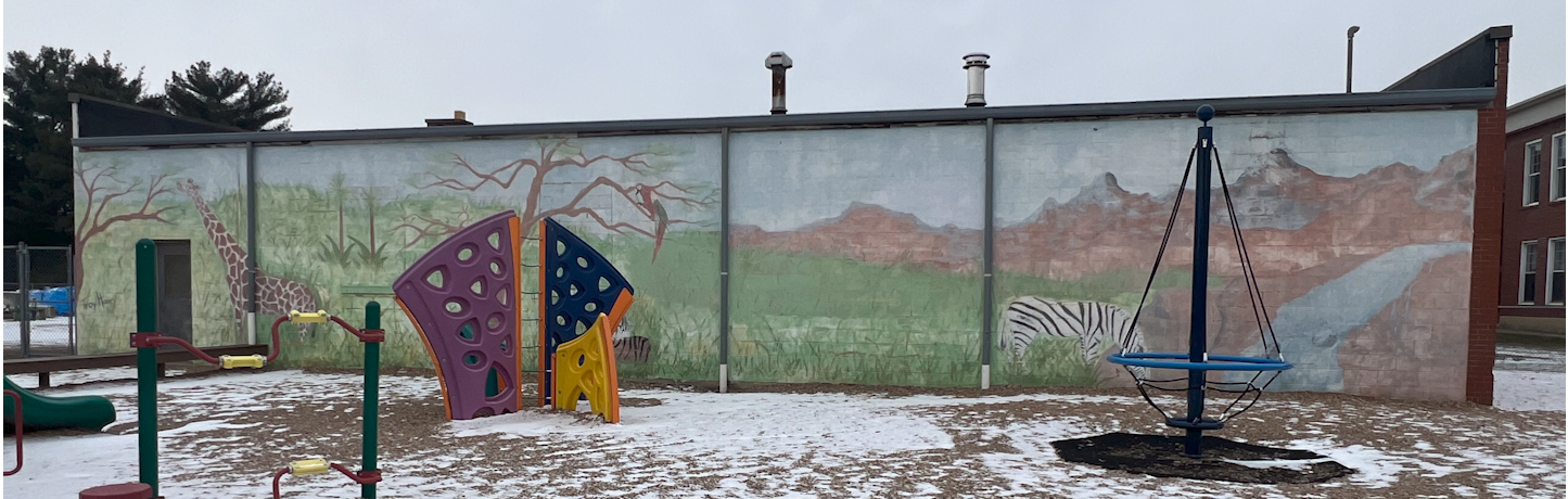playground with a faded mural of wild animals