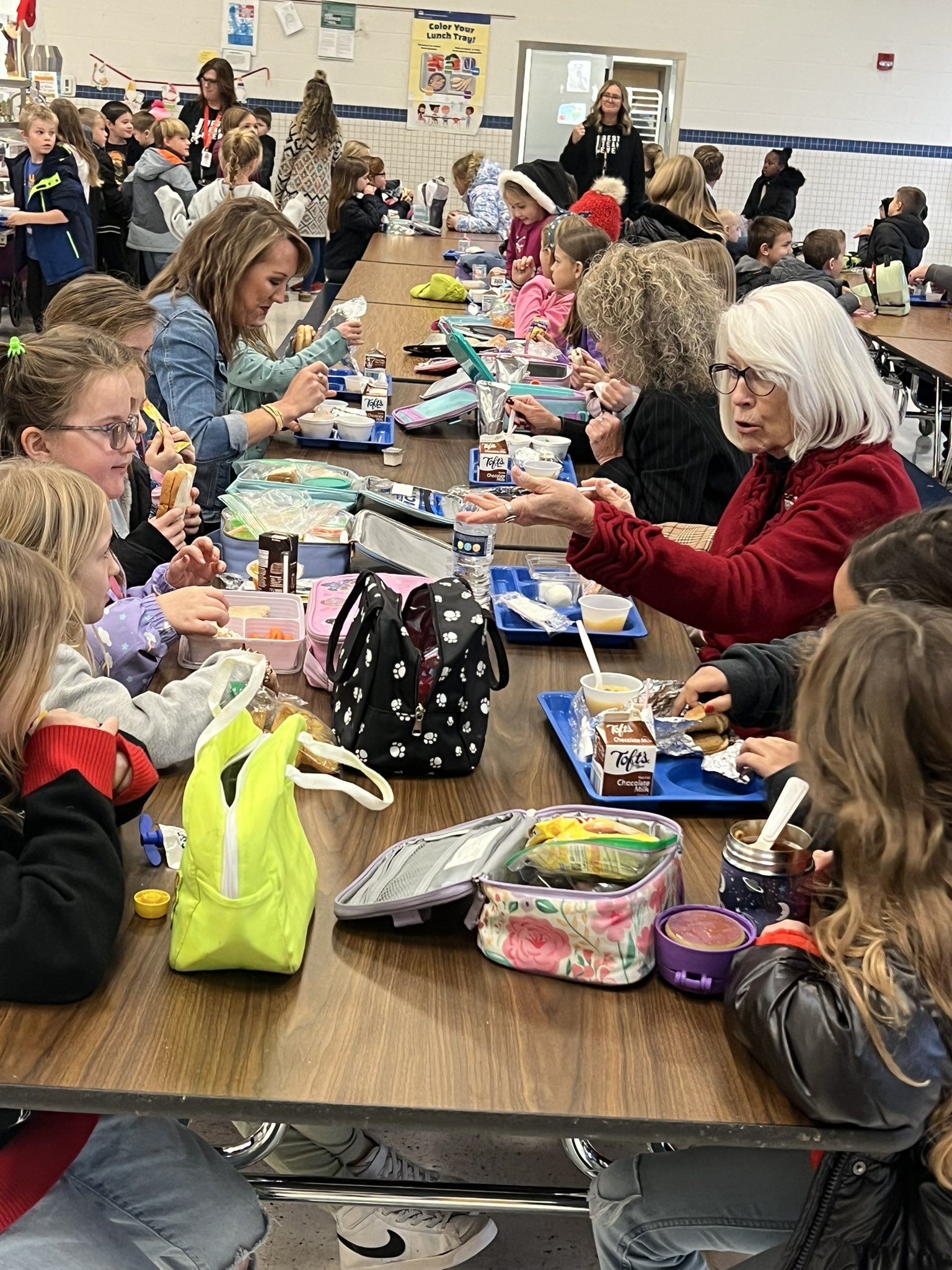 board members enjoy lunch with students at monlova primary