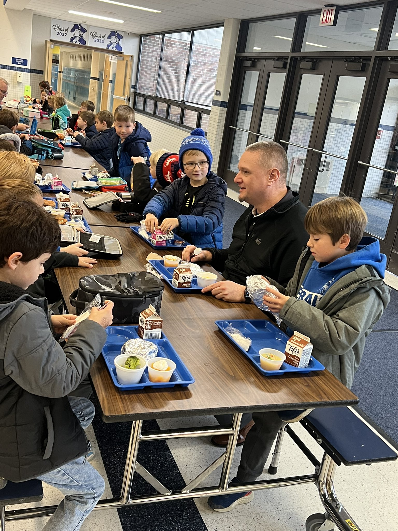 board members enjoy lunch with students at monclova primary