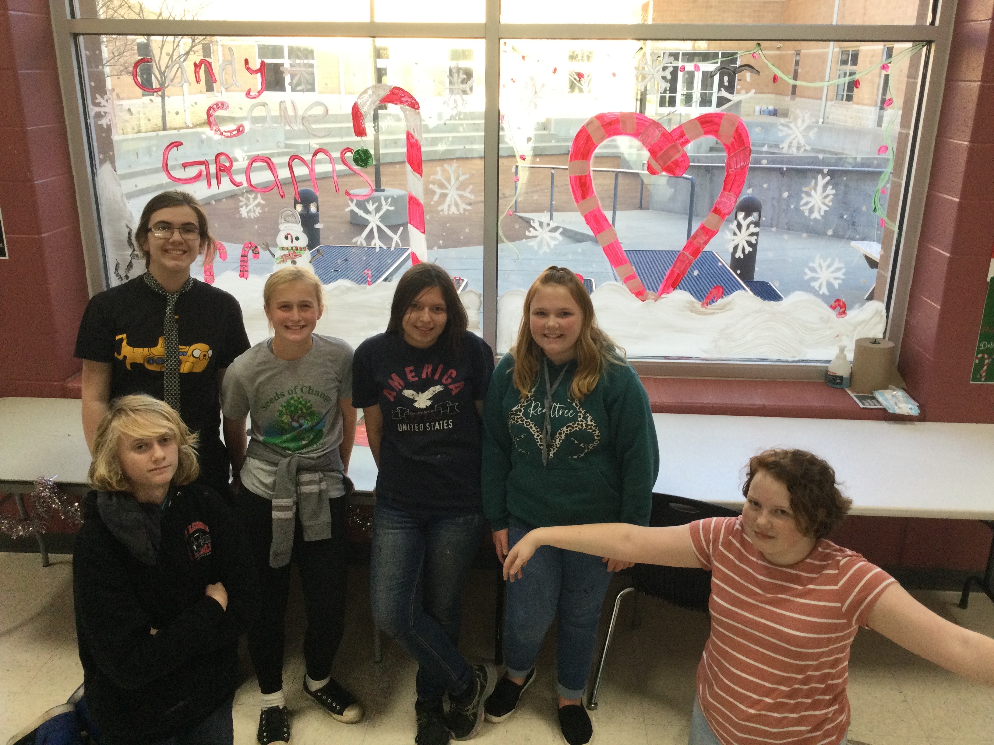 Art Club students pictured with one of their painted windows.