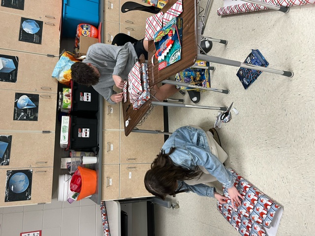Students wrapping presents.