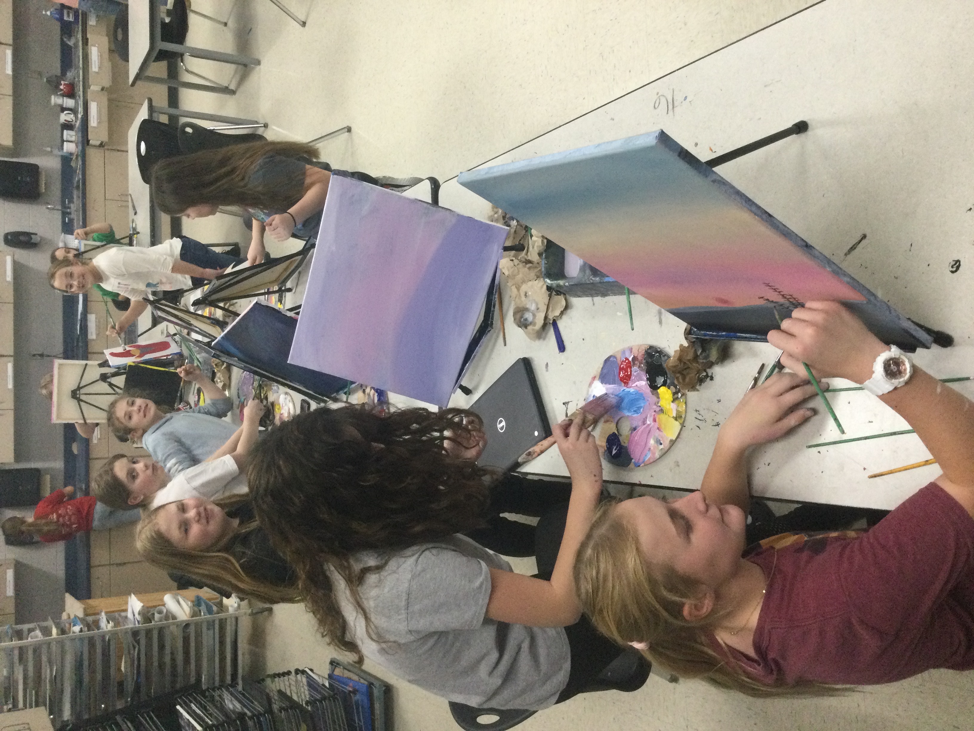 Students in art club working with canvas painting