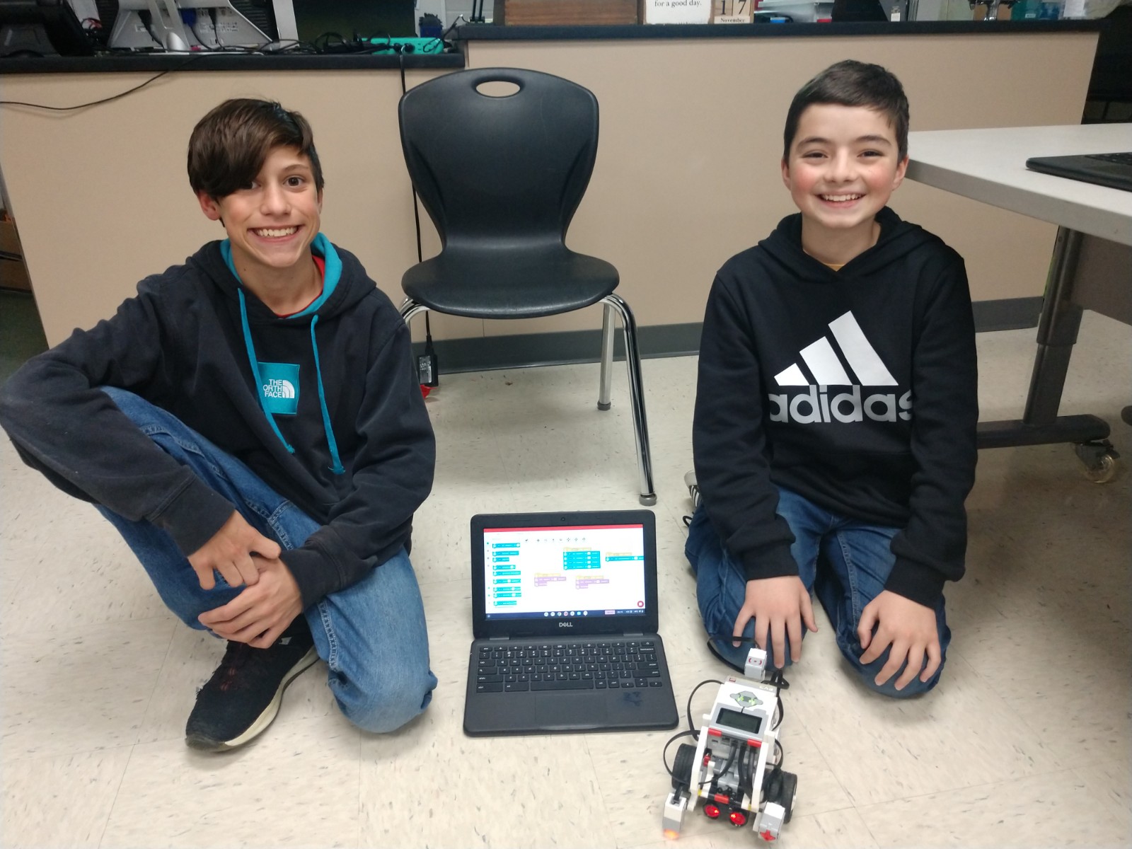 Two MS Students show off their robotic club work