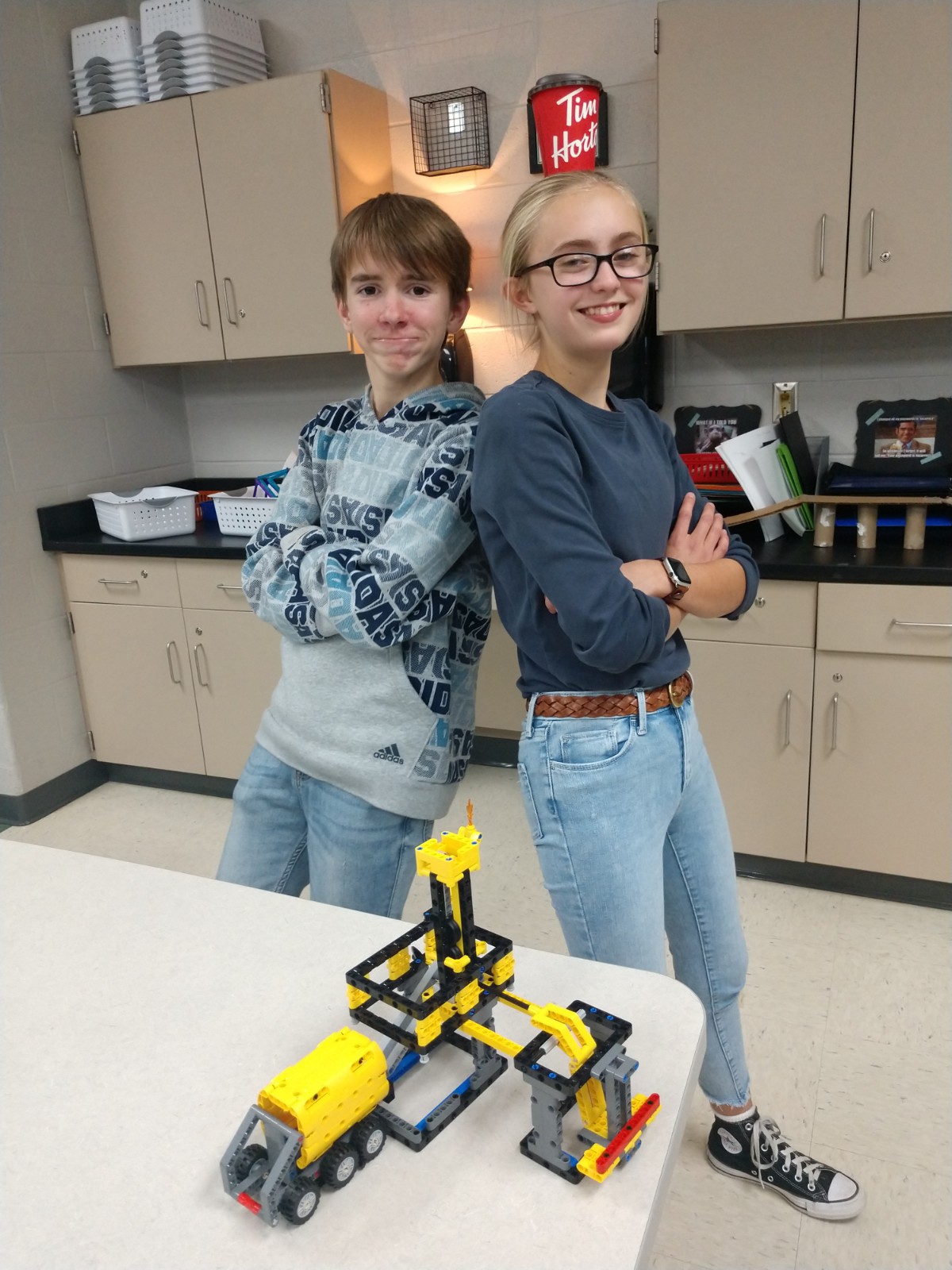 Two students show off their robotic club work
