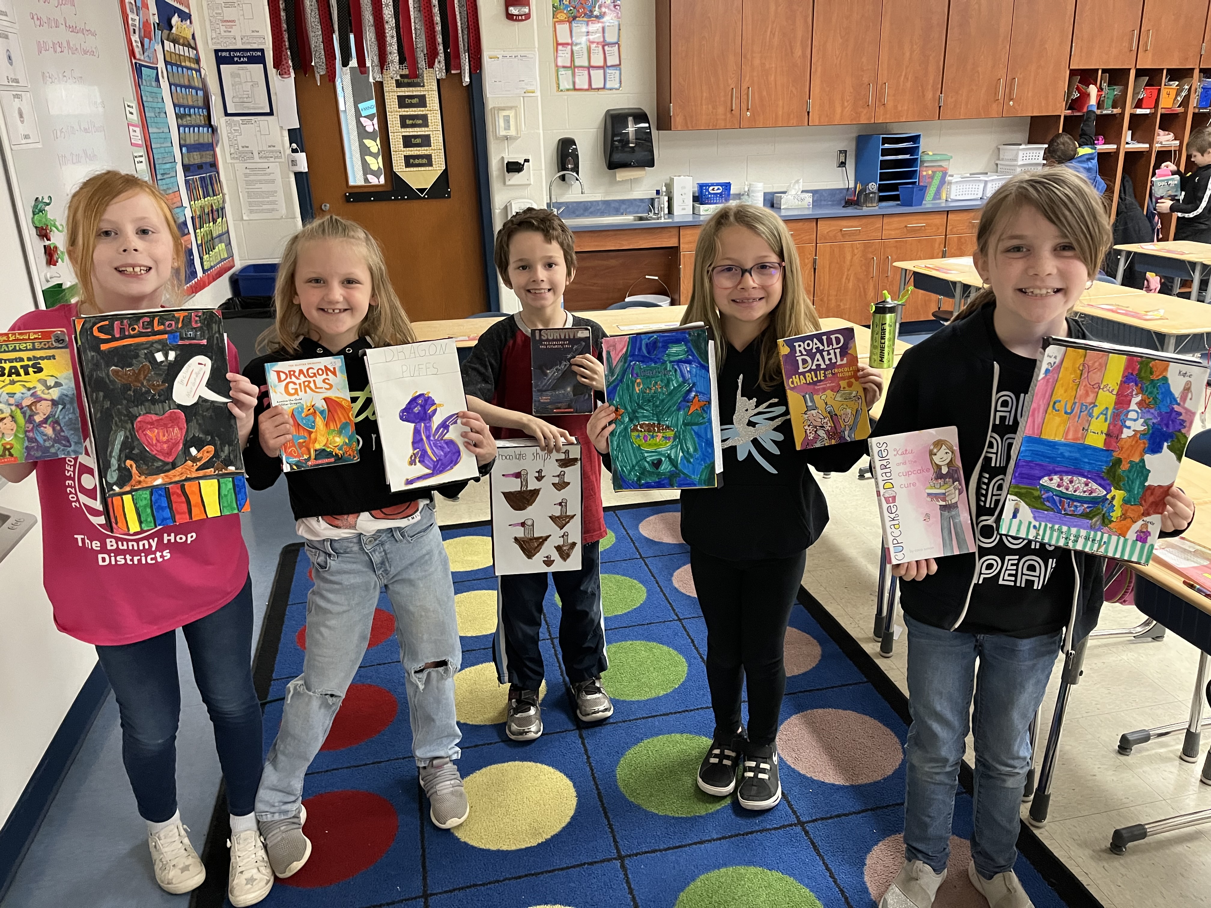 Five students pictured with their cereal box book reports