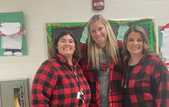 Three teachers dressed in plaid.