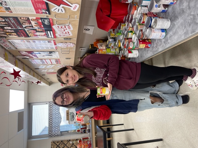 FCCLA STUDENTS COUNTING CANS FOR THE FOOD DRIVE