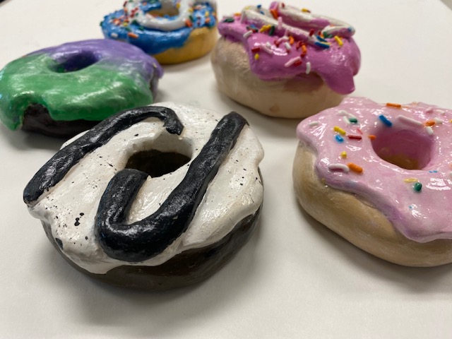 Donuts made out of clay, they have yummy looking icing and all!