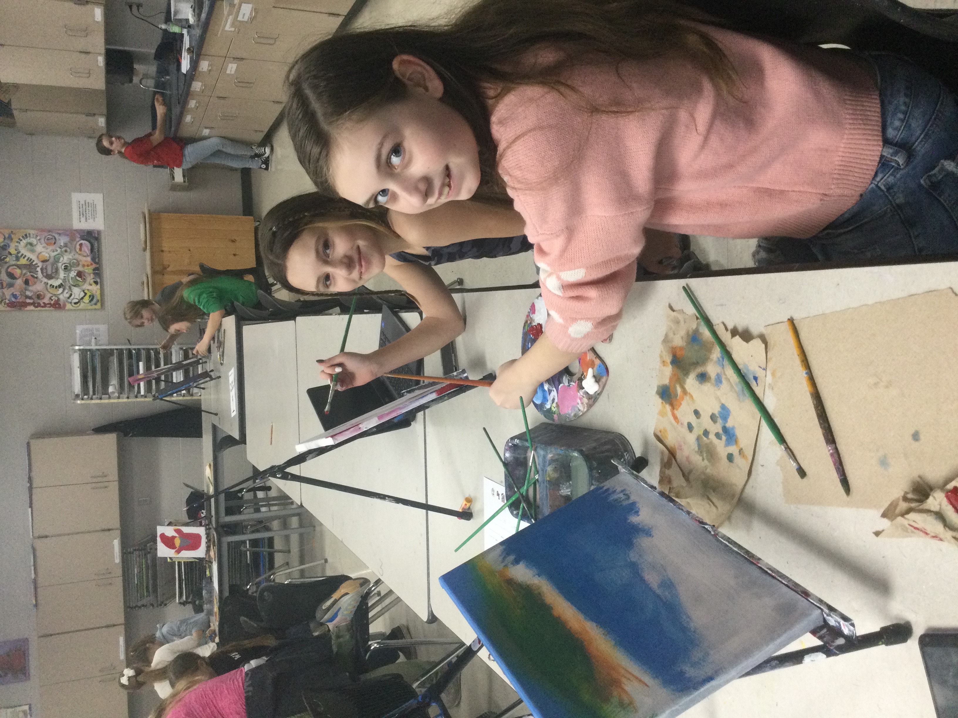 Two students pictured with their art.