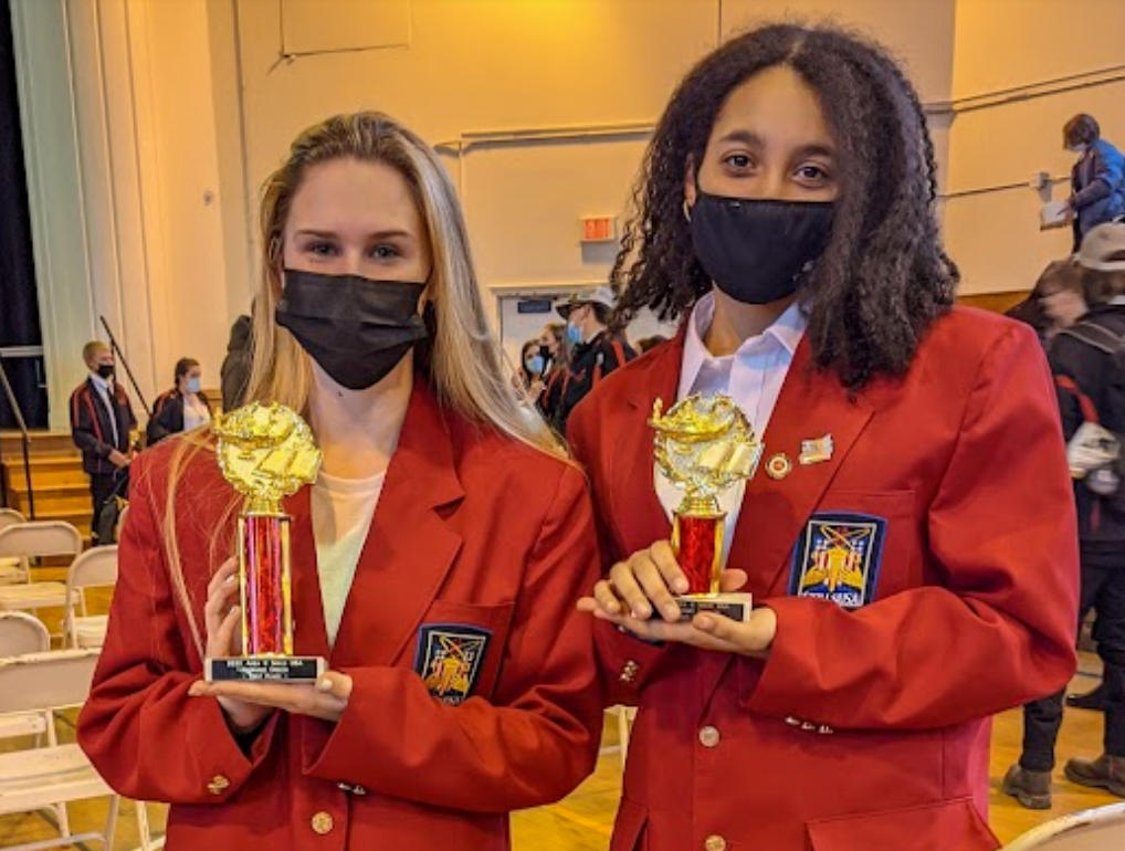 Two students from NCOC holding their trophies