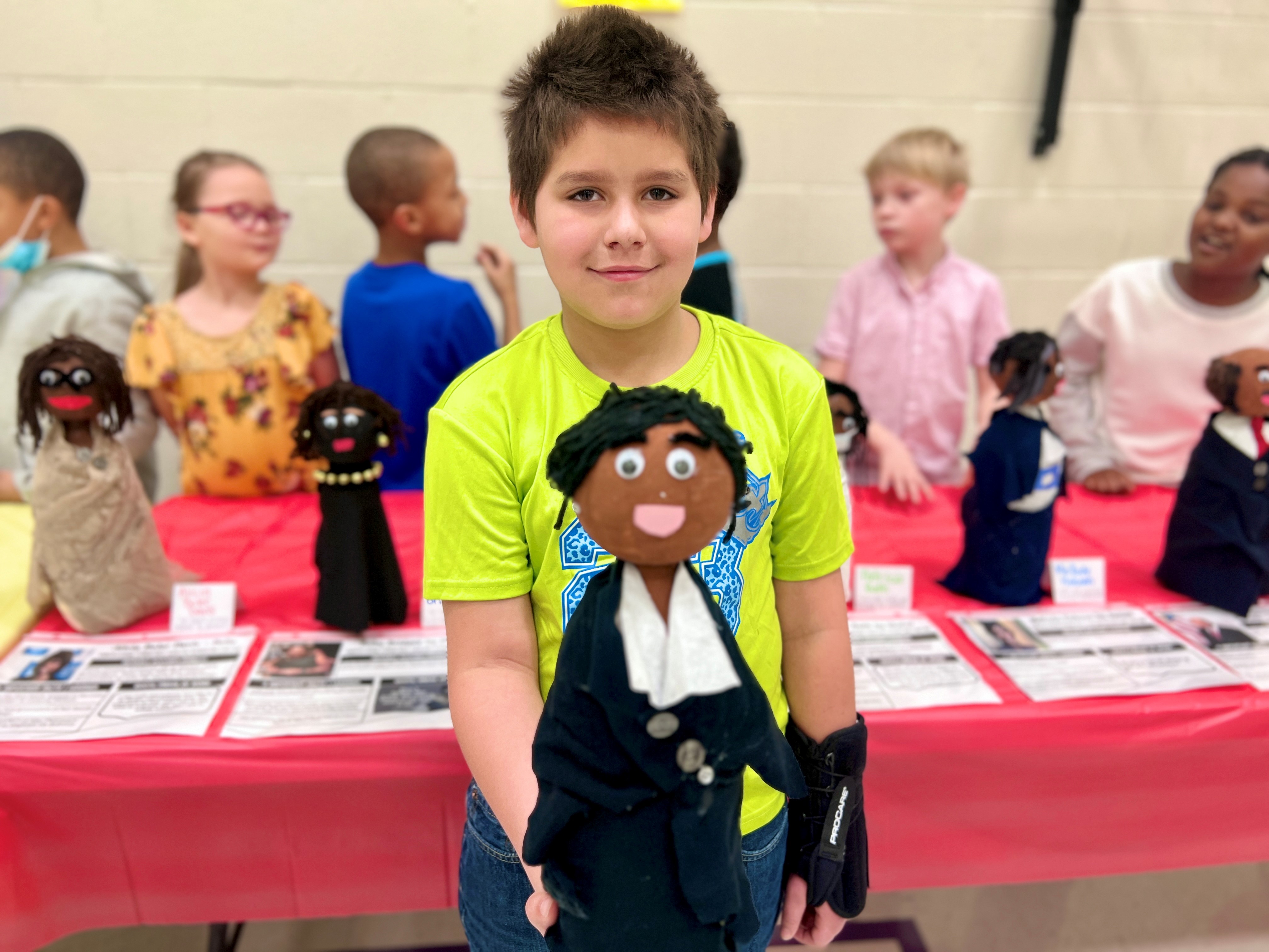 Third-grade student Xavier Berens shows off his bottle buddy of Rosalind Brewer, who is one of only two Black female  CEOs of Fortune 500 companies.